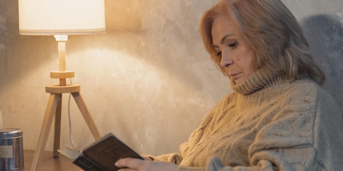 Person reading a fantasy book in a cozy chair