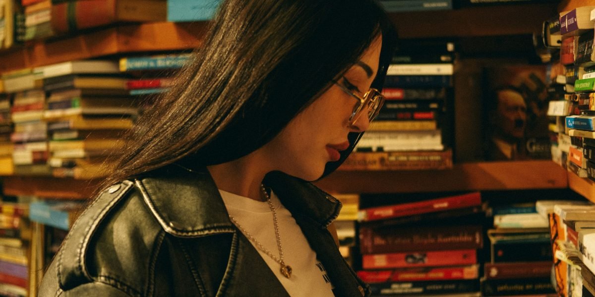 Navigating a vast array of choices, a reader contemplates their next literary adventure.