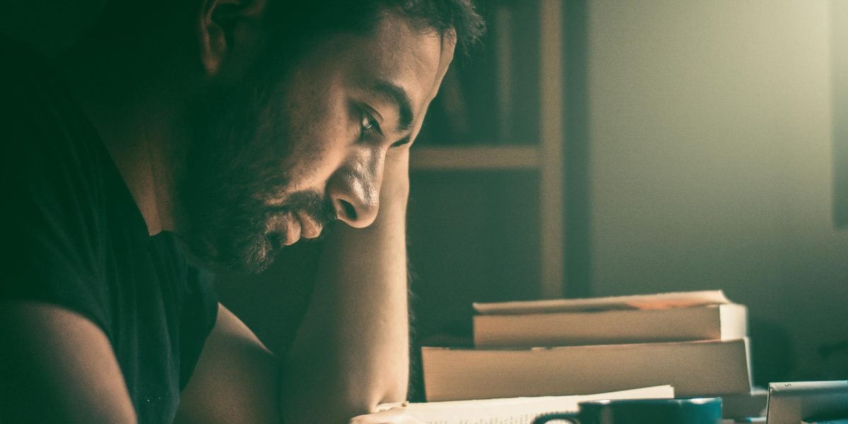 A person enjoys a quiet moment, immersed in a book, embodying the relaxing and heartwarming nature of cozy fantasy.