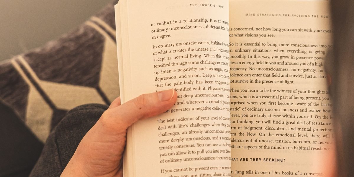 A reader lost in the pages of a compelling book, fully immersed in its deep narrative.