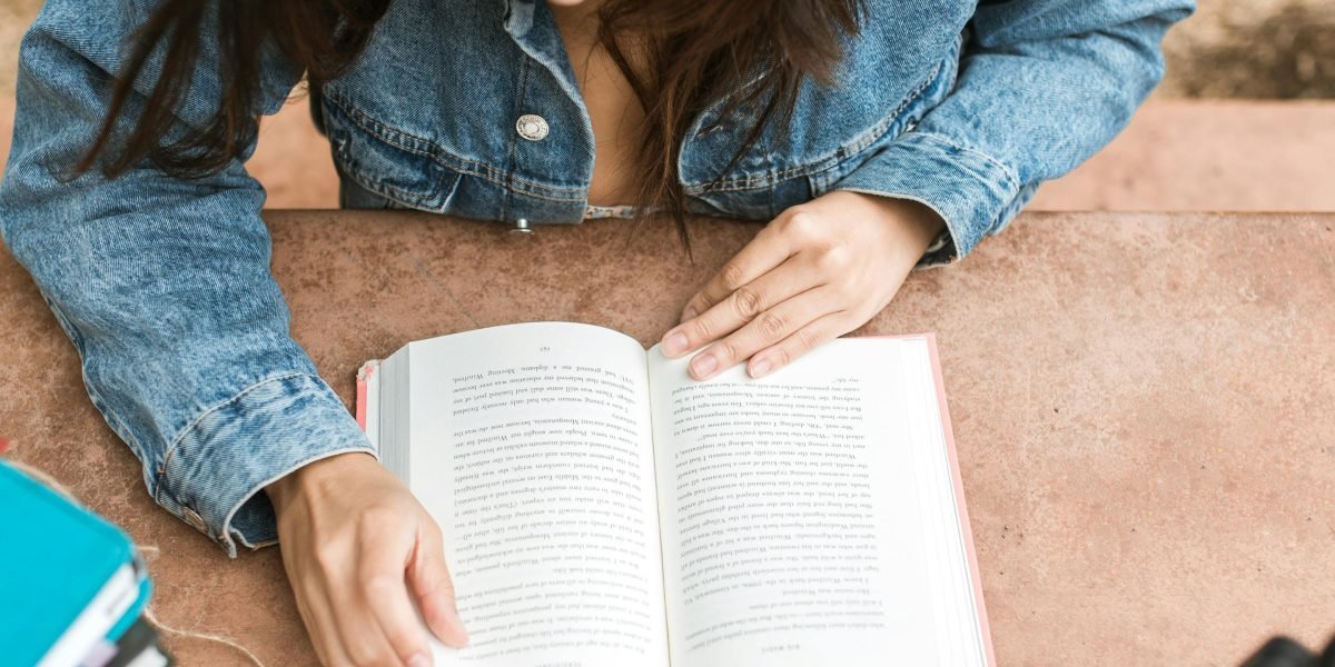 A person deeply engaged in a book, connecting with the story.
