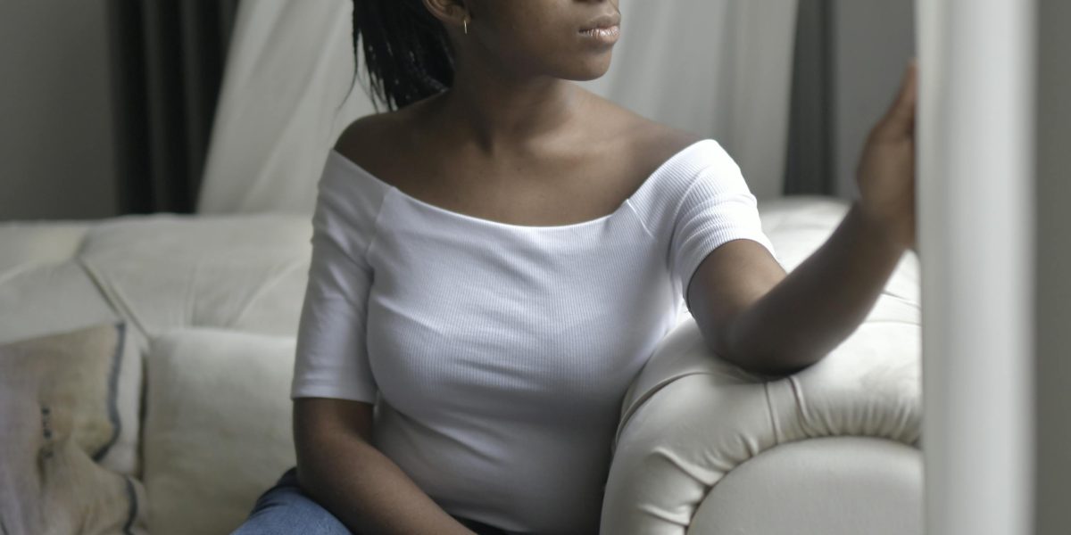 A thoughtful young person looking reflective, contemplating personal challenges or identity.