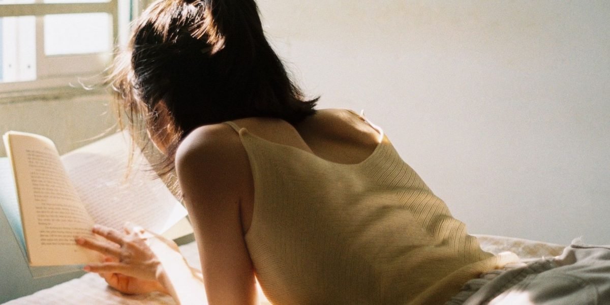 A person comfortably reading a book at home, embodying the joy of a sustainable reading habit.