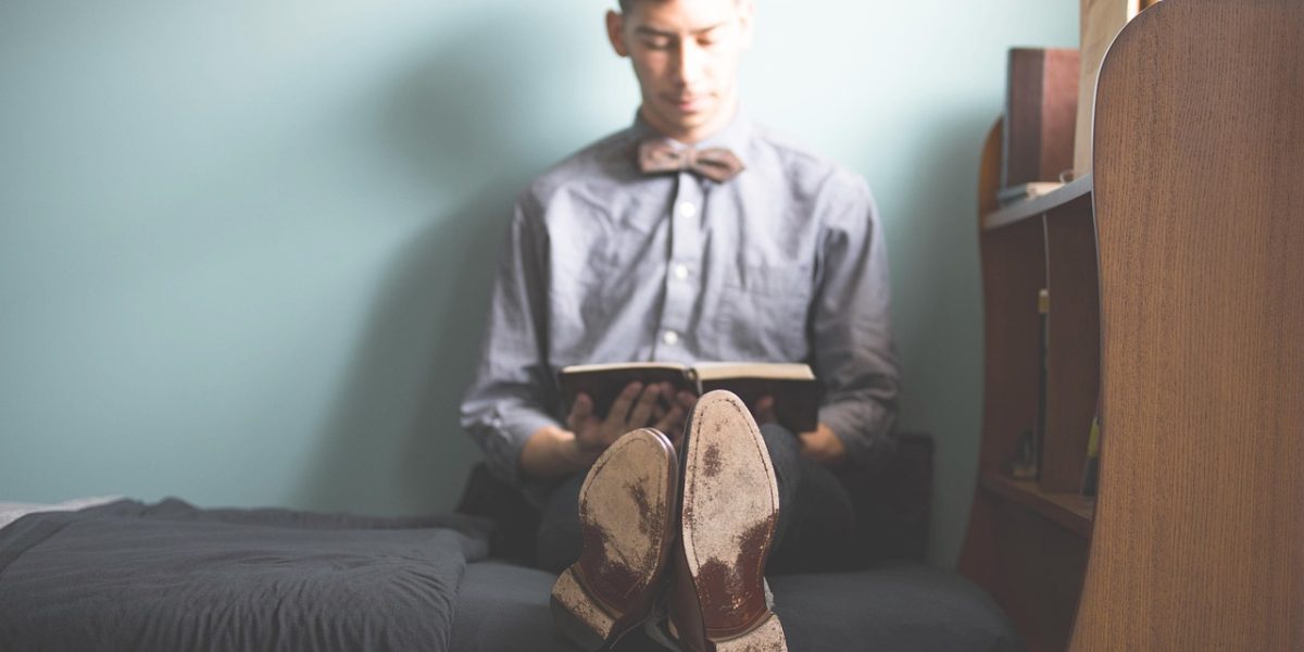 A person deeply engrossed in reading a fantasy novel, capturing the immersive experience Narnia offers.