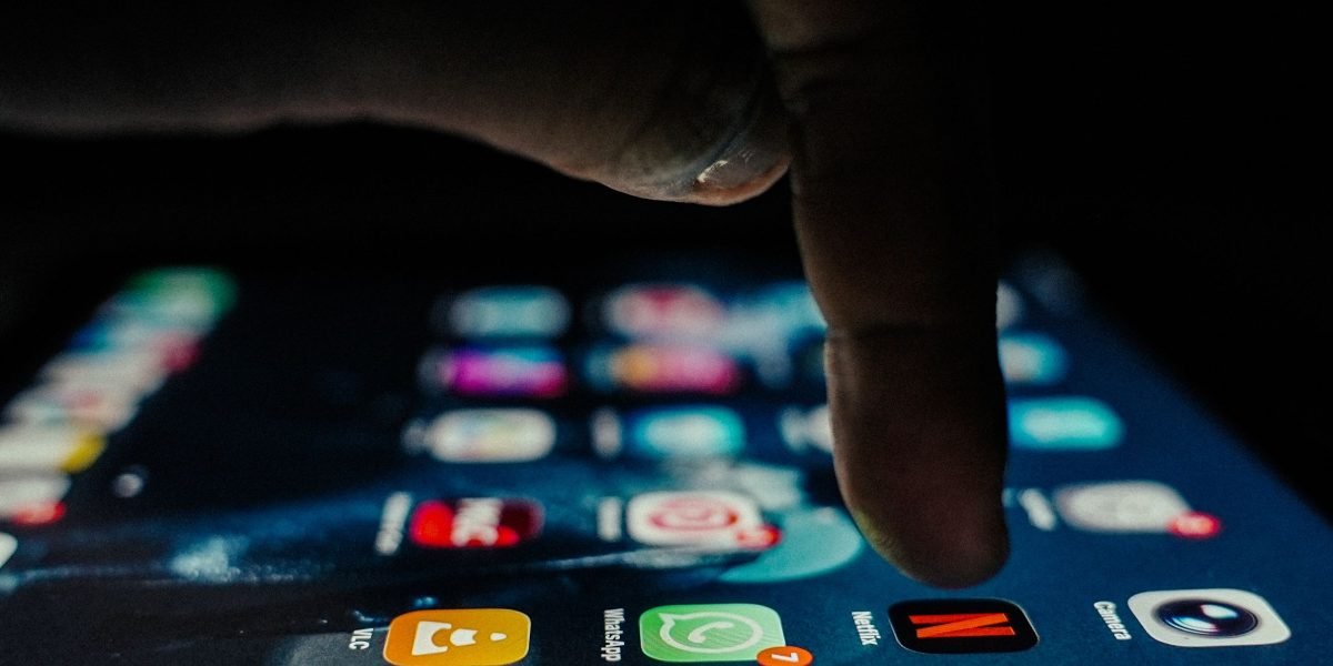 A person looking at a digital library on a tablet, symbolizing the vast choices and potential for discovery in the world of audiobooks.