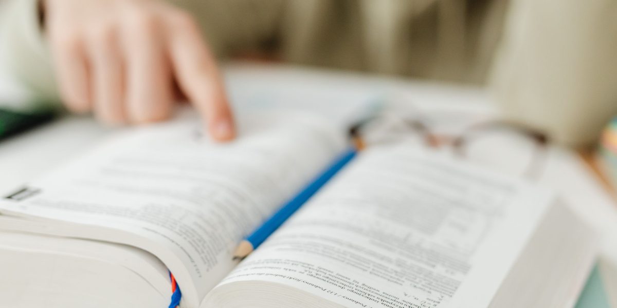 A scholar deeply focused on ancient texts, reflecting the academic roots of Tolkien's world-building.